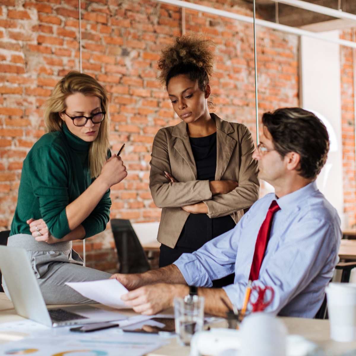 Serious workplace conversation about organizational trust and communication.